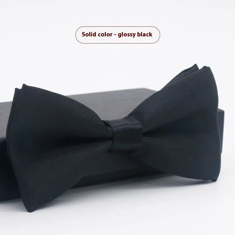 Men's flat head style polyester bow tie in a solid colour, shown with adjustable neck strap.