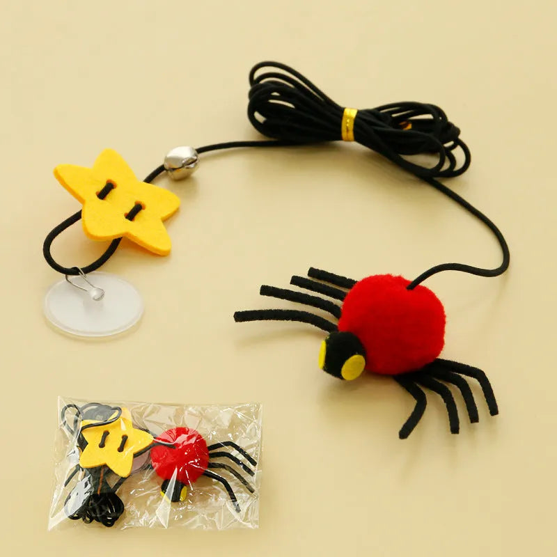 Red and yellow cat hanging door toy with elastic rope, feather, bell, and spider decoration.