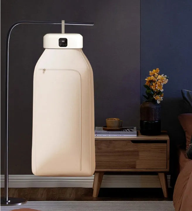 White cylindrical compact clothes dryer with remote control folded for storage