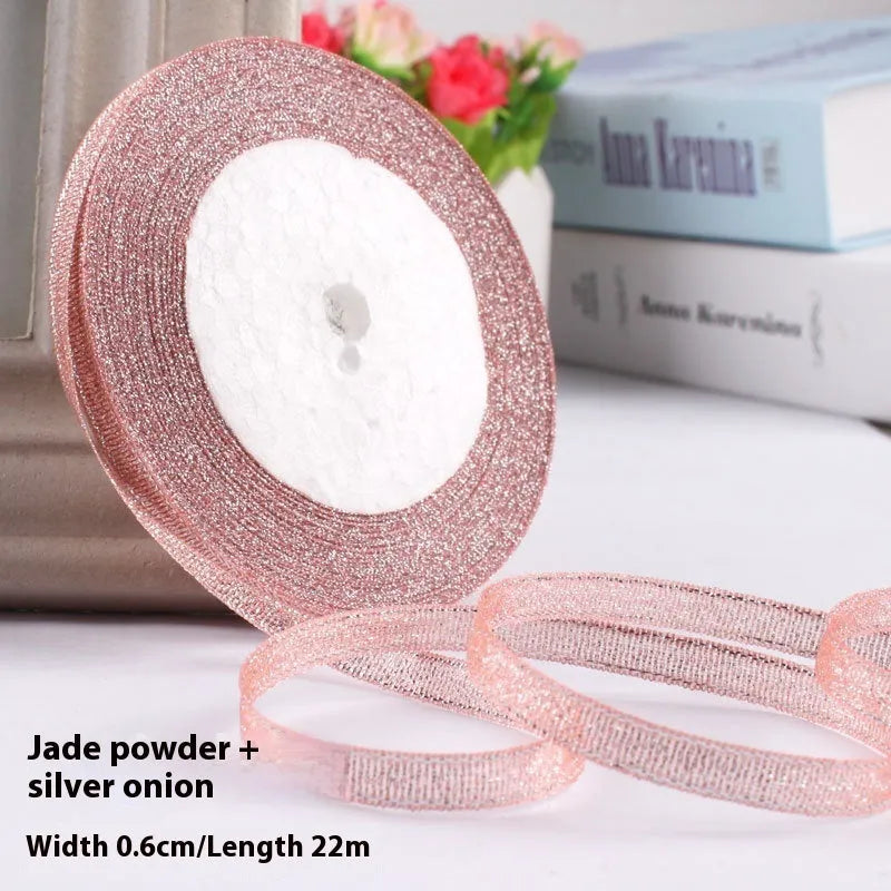 Roll of 0.6cm wide polyester gift ribbon in various colours including gold leaf, coffee and sky blue options