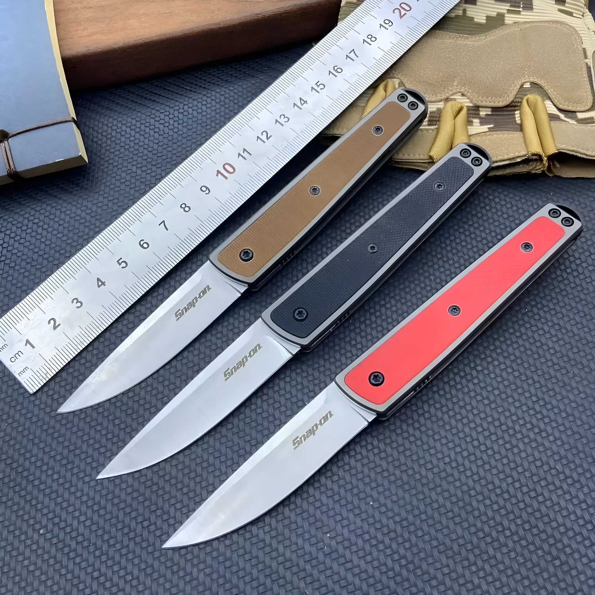 Folding fruit knife with stainless steel blade in black, brown, or red handle colours