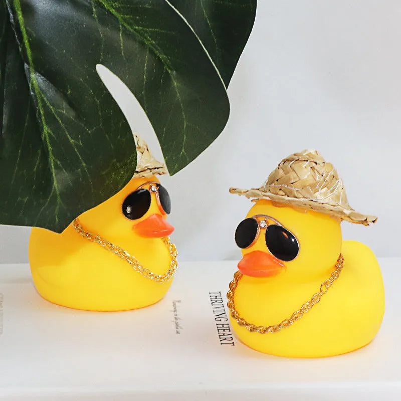 Yellow cartoon Straw Hat Duck car dashboard ornament with matte finish on a car interior.