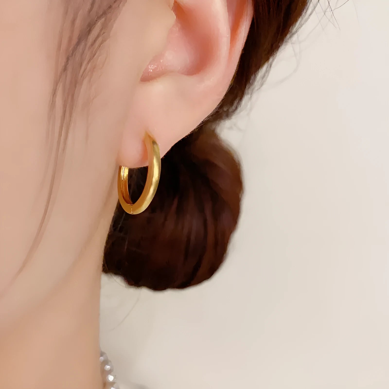 Women's geometric ear clip with round design in gold and silver plated finishes