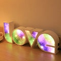 Colourful LED love light decorative lamp with plastic shell on a table