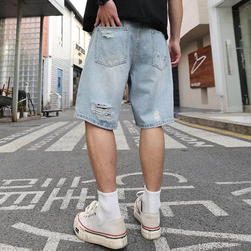 Light blue ripped denim shorts with distressing and straight-leg cut for casual hip hop style