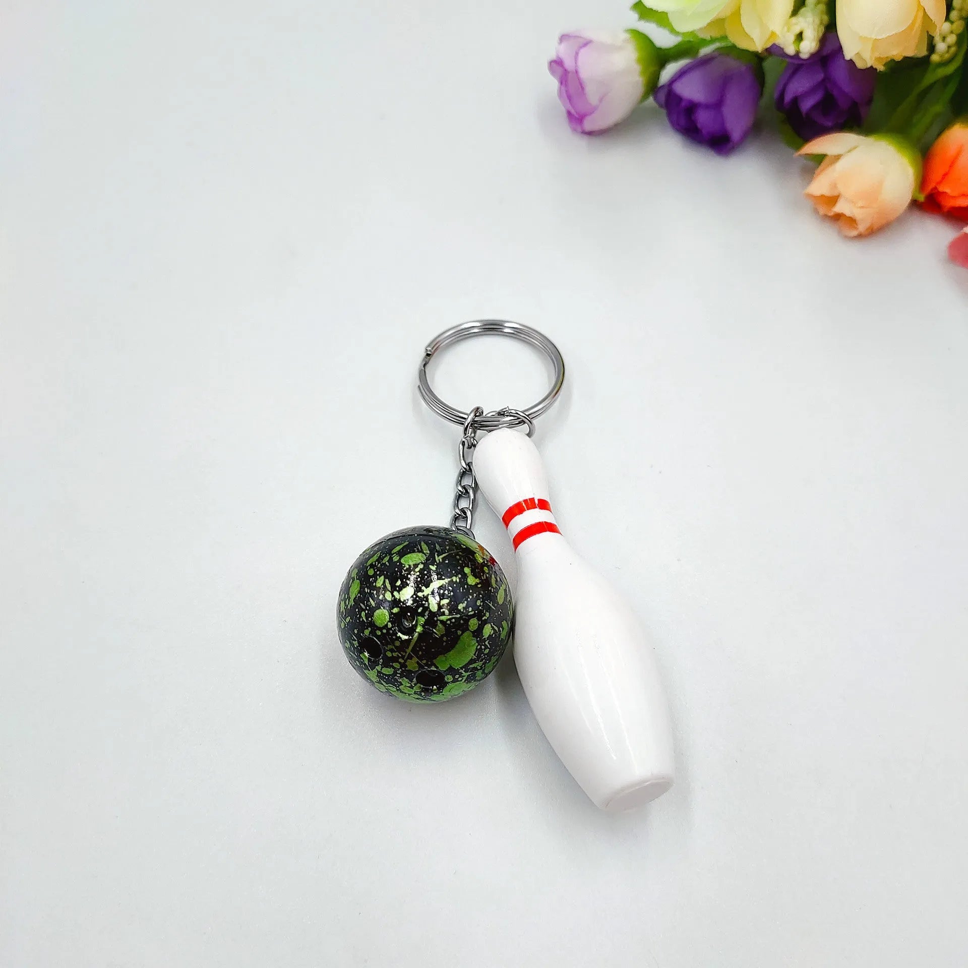 Mini simulation sports bowling pin keychain pendant in blue, dark red, green, or purple colour options.