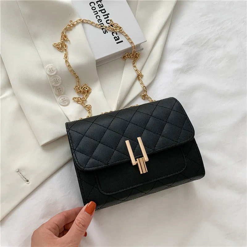 Women's diamond lattice chain crossbody bag in black with adjustable shoulder strap