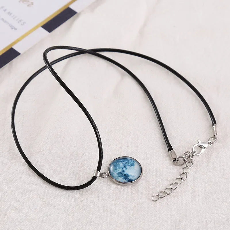 Luminous constellation pendant necklace with adjustable chain on a plain background.