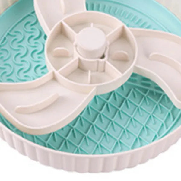 Rotating pet food bowl with silicone slow feeder mat in blue with windmill pattern design