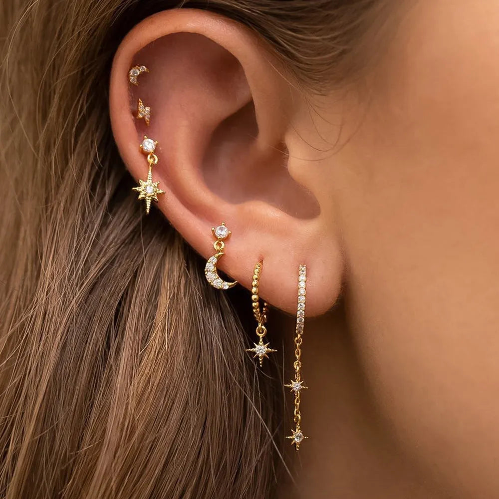 Set of six gold-coloured XINGX women's earrings with zircon studs and chain tassels.