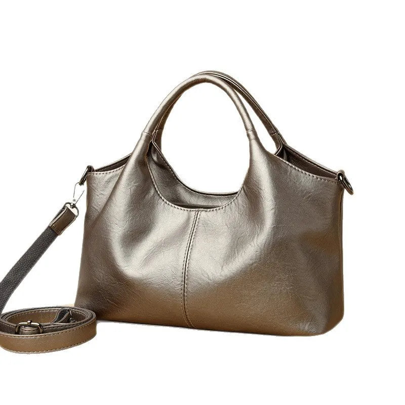 Women's genuine leather crossbody bag in beige colour showing soft construction and large capacity