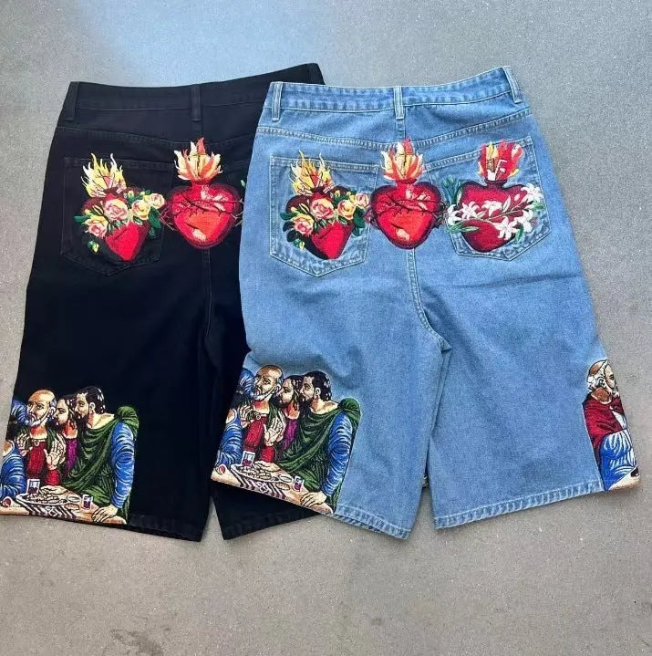 Blue cotton men's shorts with a Jesus Christ screen print on the back pocket, showing tapered leg fit.