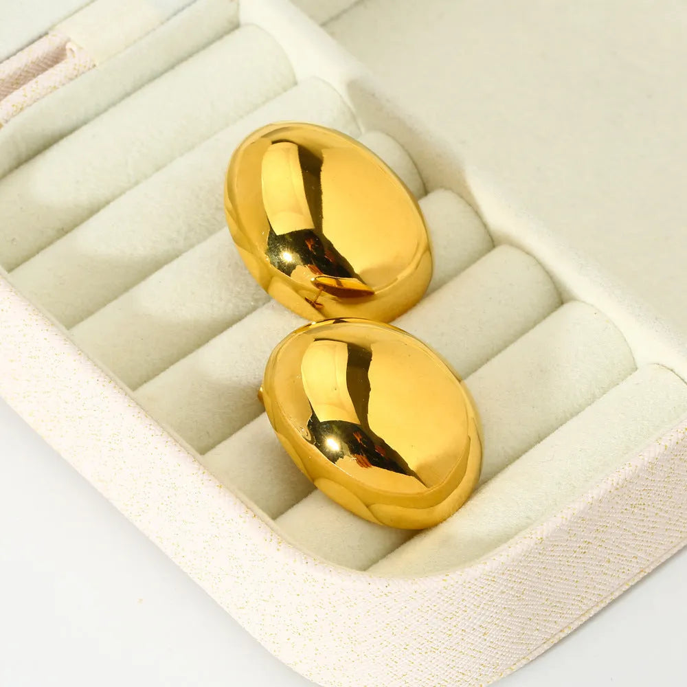 Geometric women's earrings with a gold glazed finish and simple line designs on a white background.
