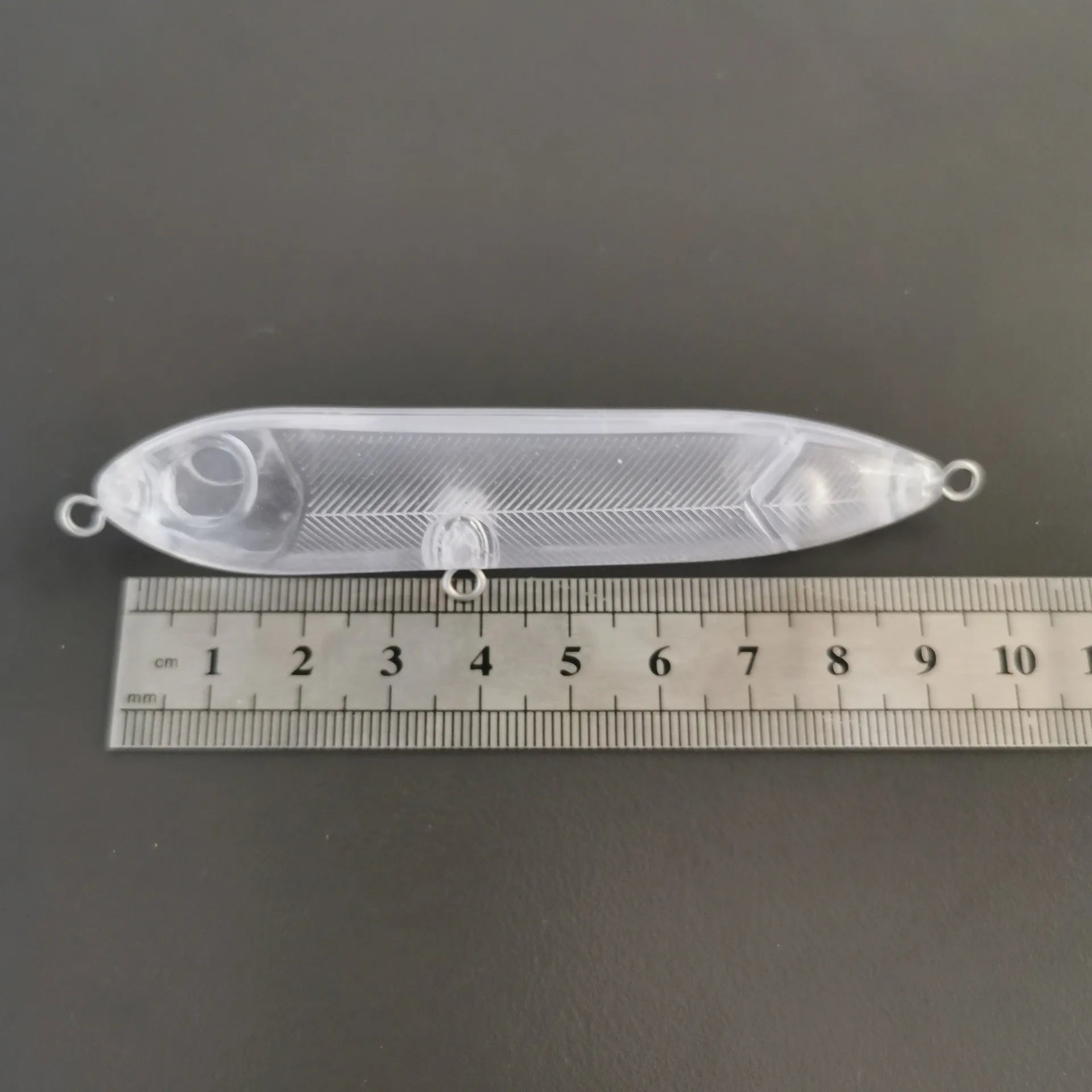 Transparent 9.5cm long ABS plastic blank lure body with a 7mm eye hole for DIY fishing bait creation.