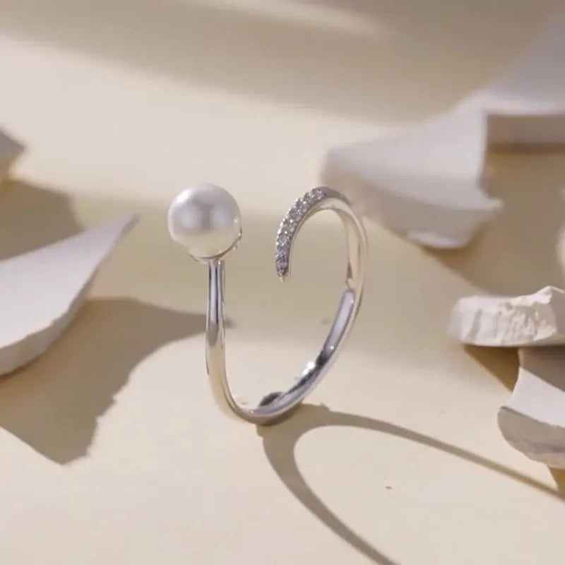 Adjustable S925 sterling silver ring for women featuring a natural shell pearl on an open loop band.
