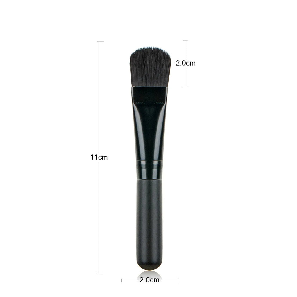 Wooden handle portable facial treatment brush with artificial fibre bristles on white background