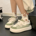 Green women's casual lace-up shoes with PU mesh upper and flat heel on a white background.