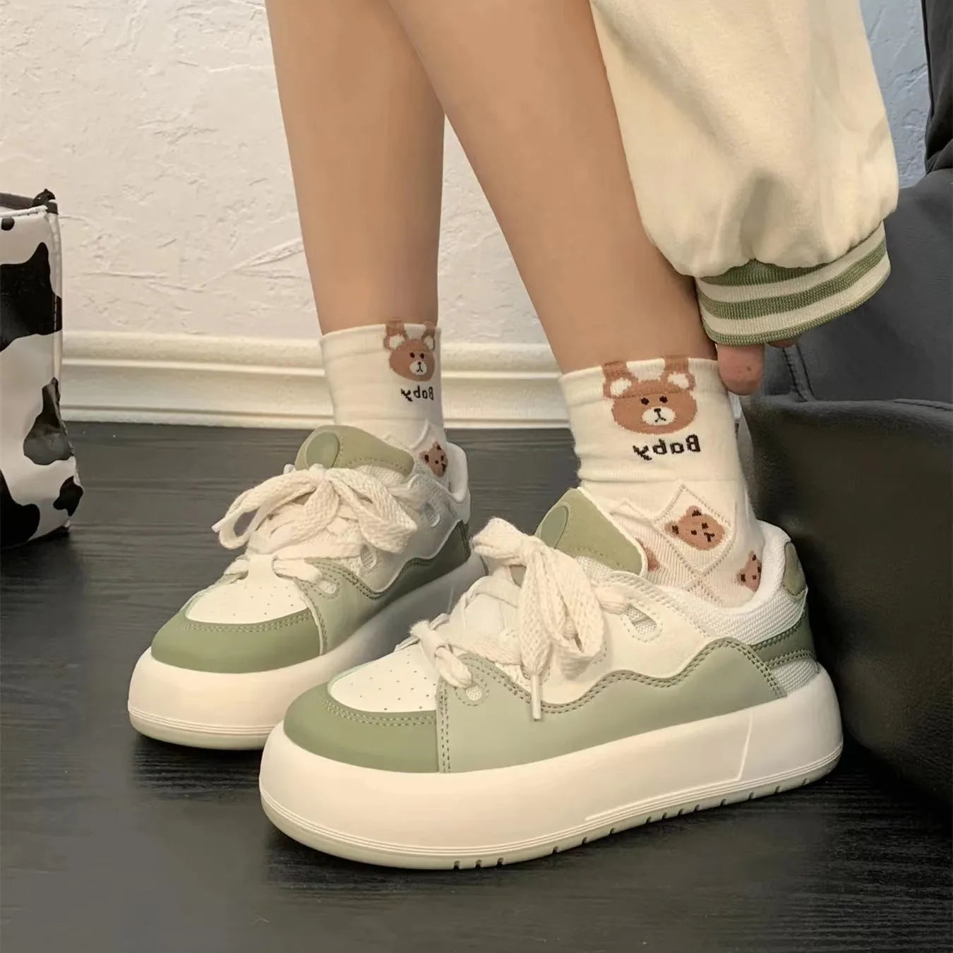 Green women's casual lace-up shoes with PU mesh upper and flat heel on a white background.