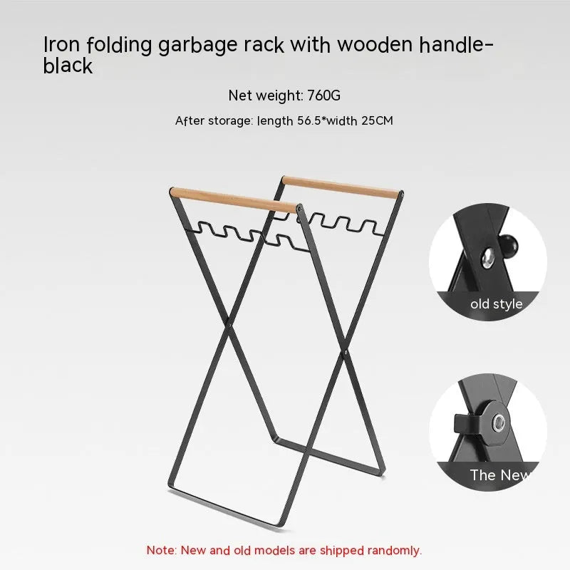 Black iron folding trash storage rack with wooden handle mounted on a wall.
