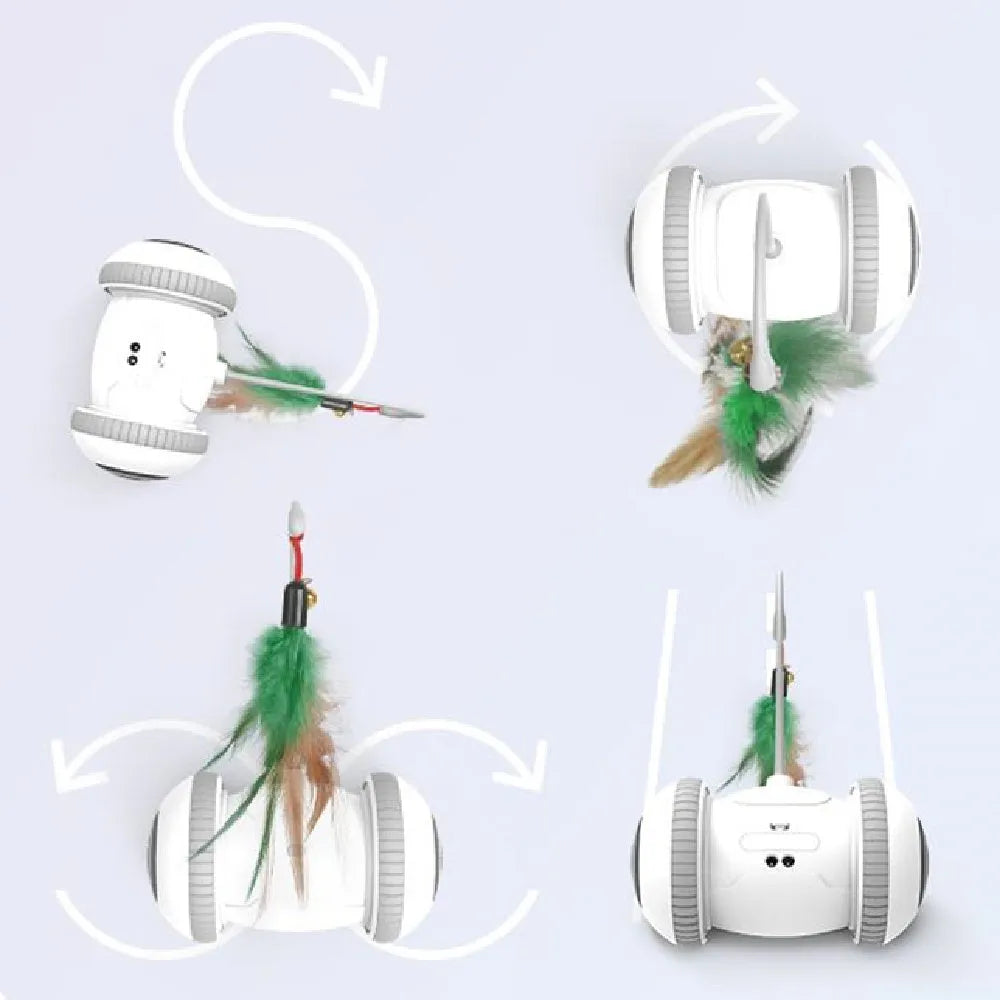 White and grey automatic interactive cat toy with interchangeable feather accessory on a floor, USB cable attached