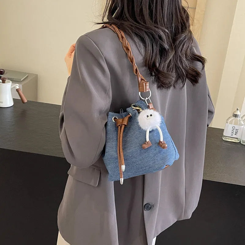 Blue synthetic leather cross-body bucket bag with adjustable strap and sandwich pocket
