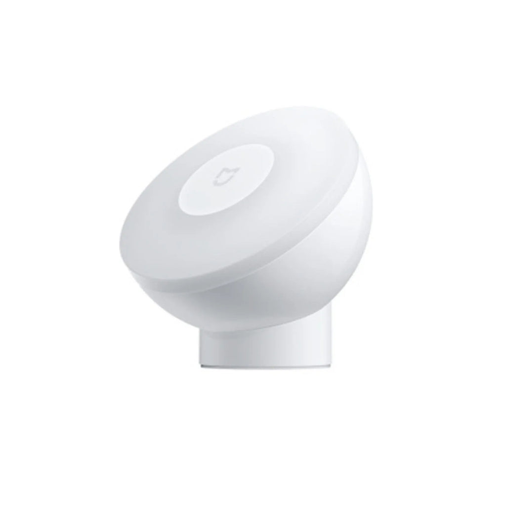White modern bedside table lamp with human body induction and Bluetooth on a nightstand.