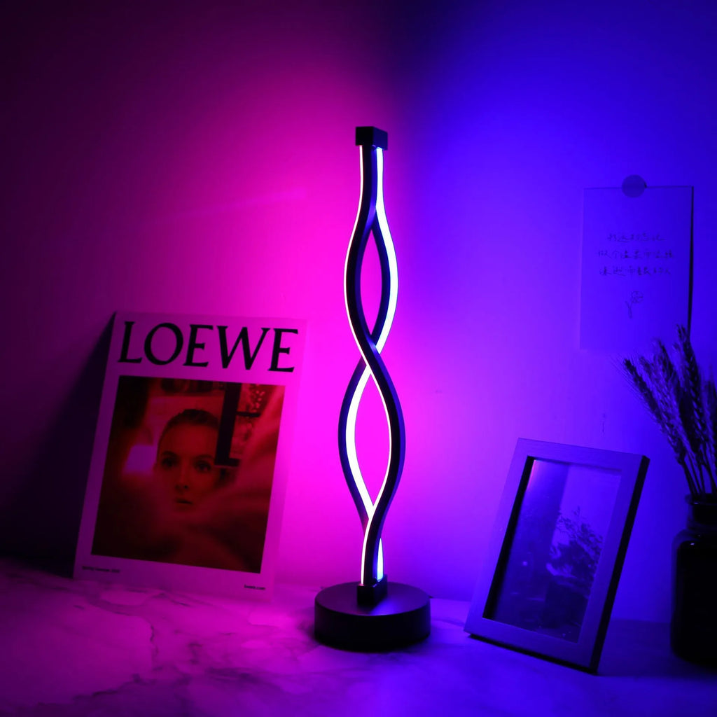 Black aluminium desk lamp with a dimming button and touch controls for blue and pink light