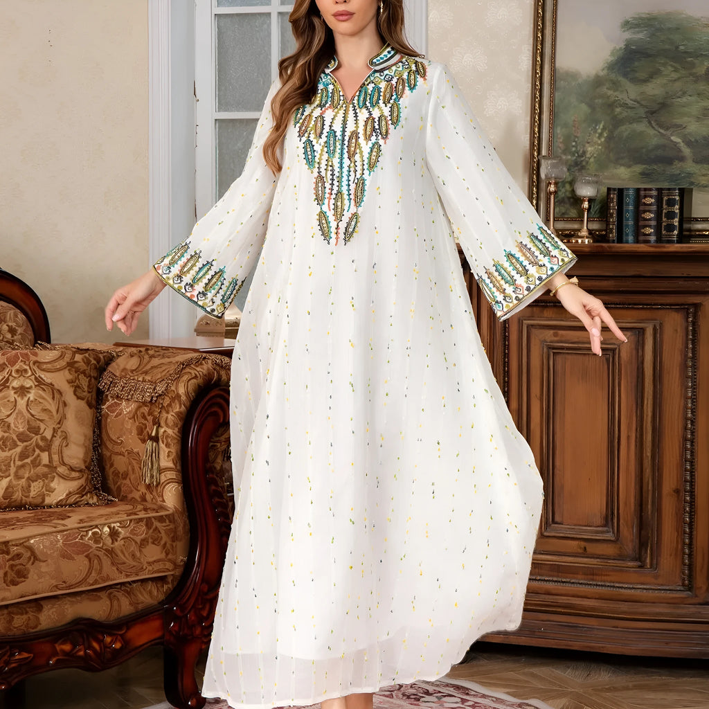 White long sleeve long skirt Arabic robe for women on a hanger.