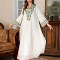 White long sleeve long skirt Arabic robe for women on a hanger.