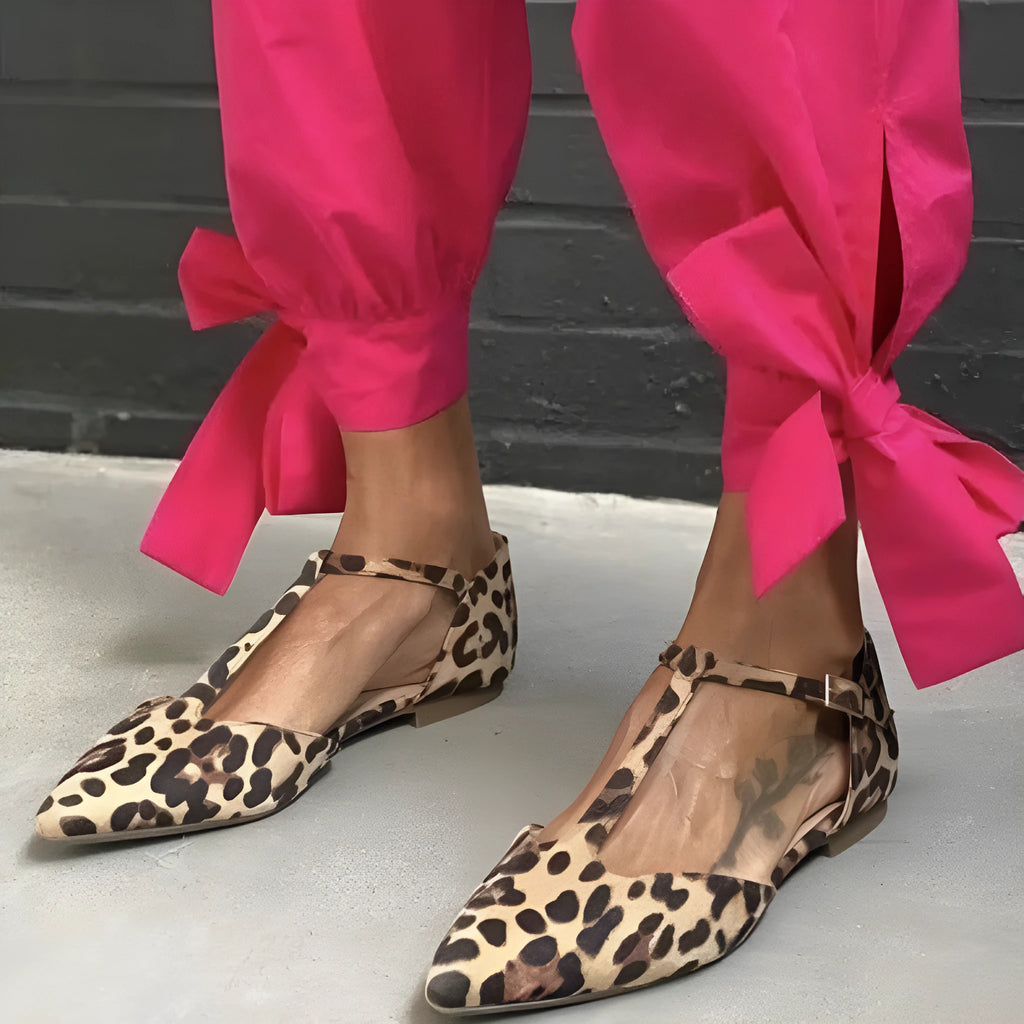 Leopard print women's pumps with pointed toe and low chunky heel featuring cross shoulder straps