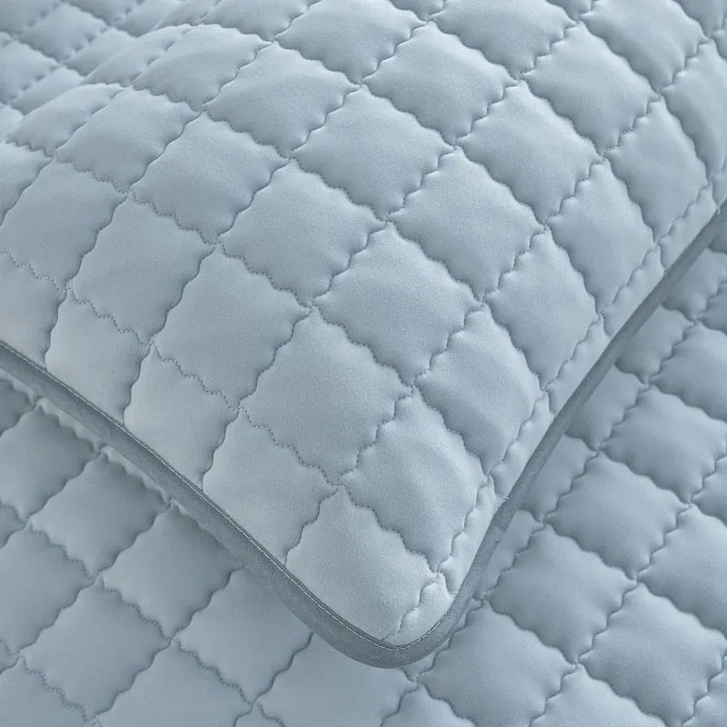 Blue waterproof fitted sheet with elasticated corner on a mattress