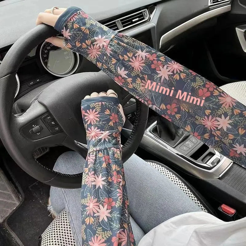 Printed viscose fibre sun protection oversleeves in floral design with elasticated cuffs.