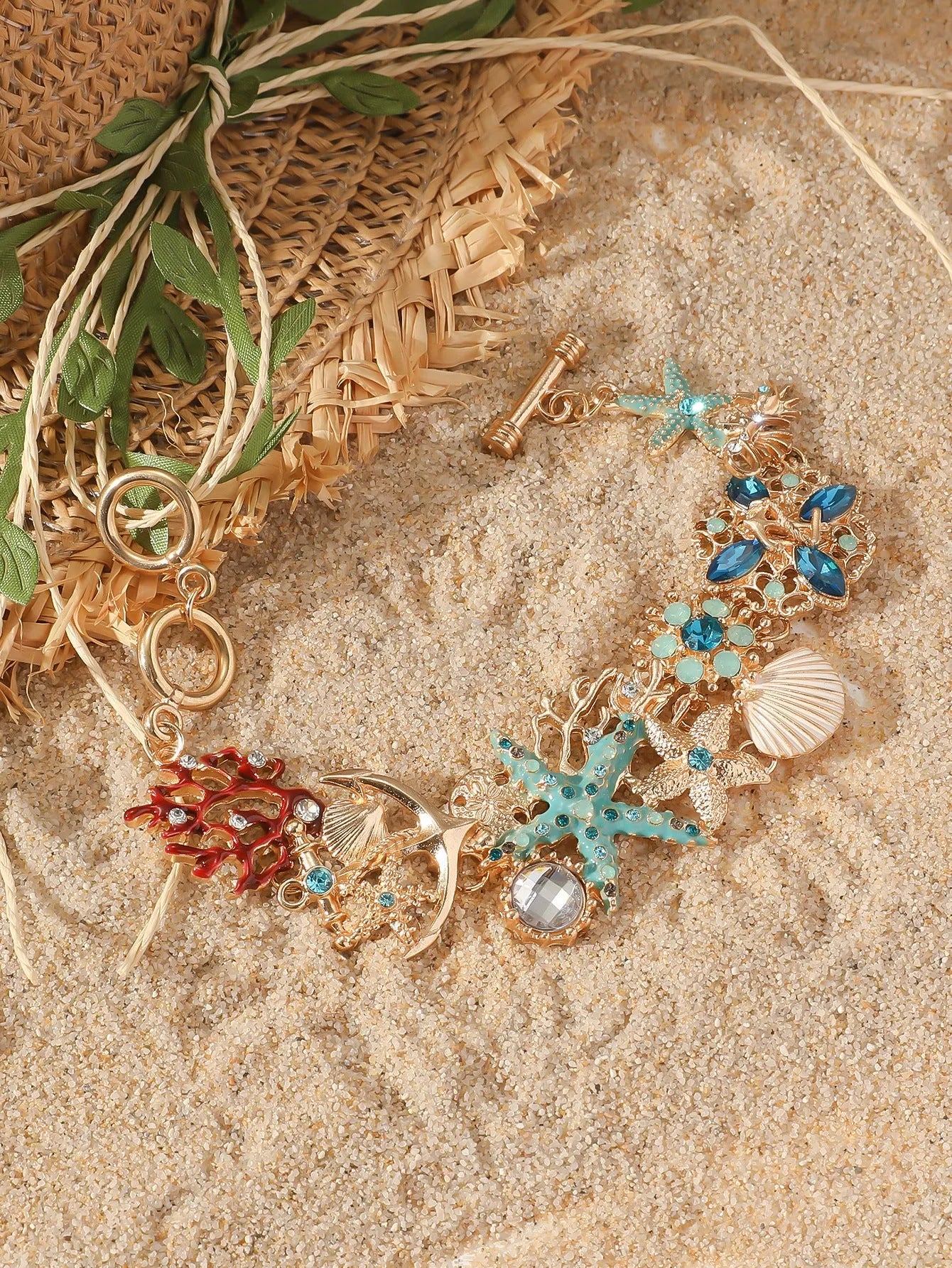 Women's alloy bracelet with a rhinestone-studded boat anchor and starfish charm in blue, red, or turquoise.