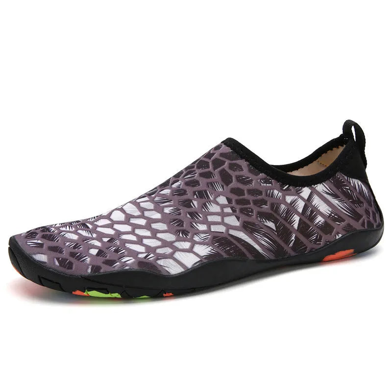 Blue Lycra beach wading shoes with EVA midsole on a sandy beach