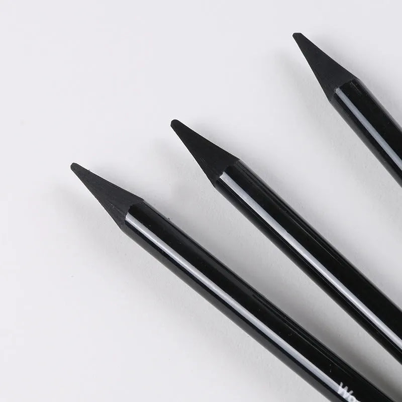 Set of six graphite and three carbonized drawing pencils with wooden casings on a suction card.