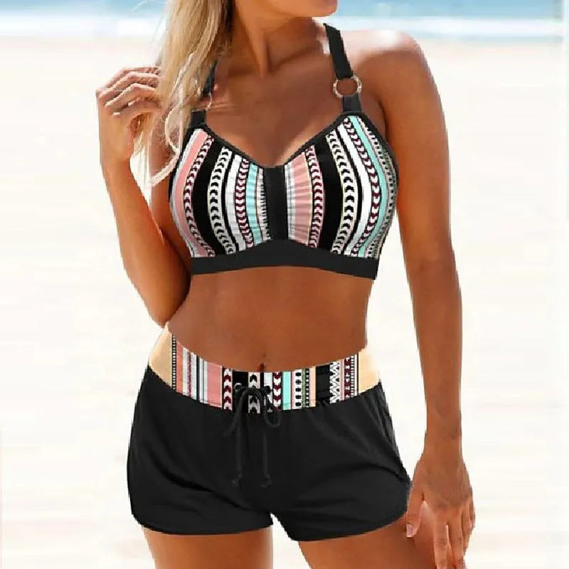 Women's navy blue and print two-piece bikini swimsuit made from polyester.