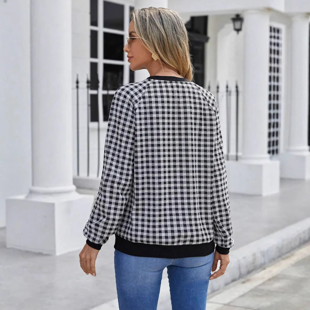 Black Japanese plaid pattern long sleeve polyester pullover sweater on a hanger