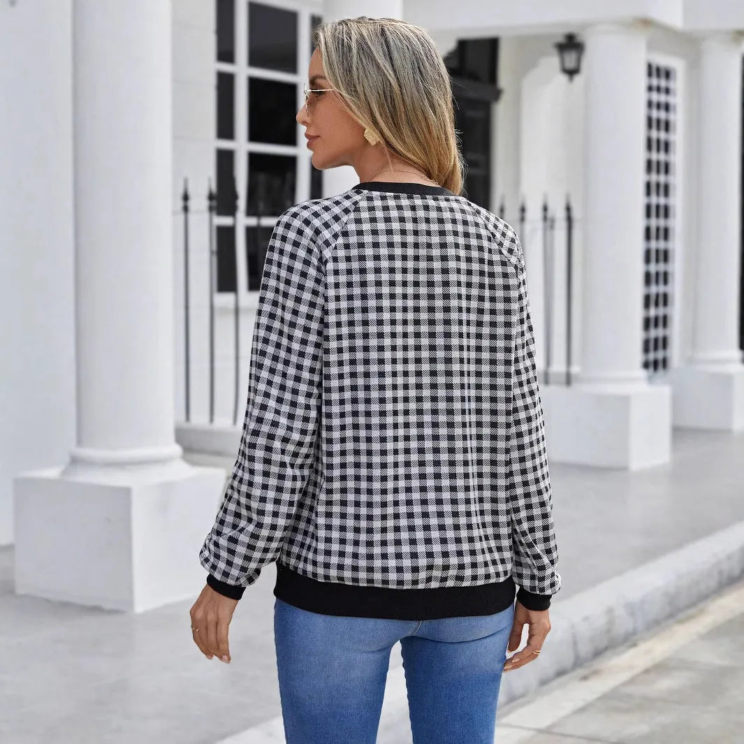 Black Japanese plaid pattern long sleeve polyester pullover sweater on a hanger