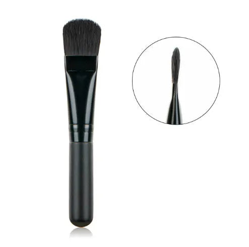 Wooden handle portable facial treatment brush with artificial fibre bristles on white background