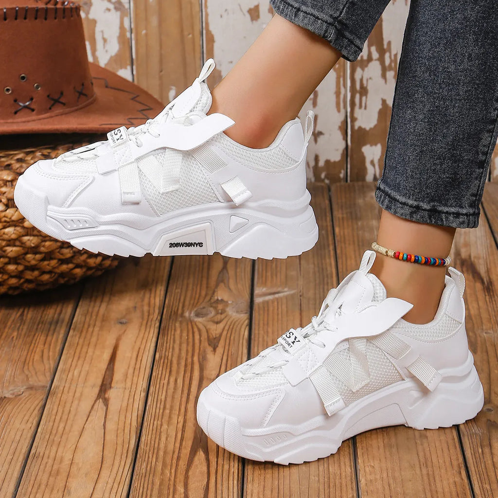 Women's purple platform sneaker with breathable mesh upper and lace-up front on a neutral background.