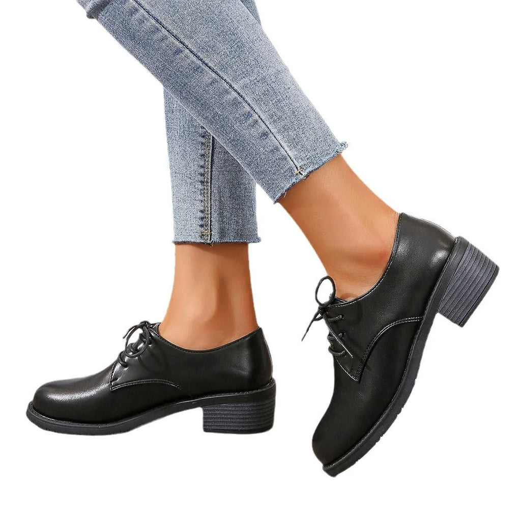 Black women's low-top slip-on work shoes with a chunky mid-heel and rounded toe.
