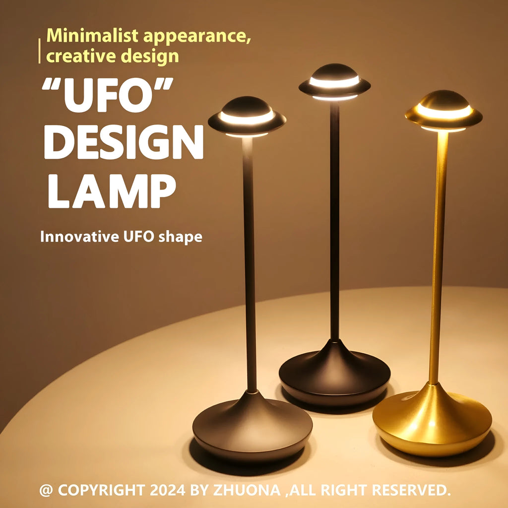 Creative metal UFO table lamp in black with touch dimming on a wooden desk.
