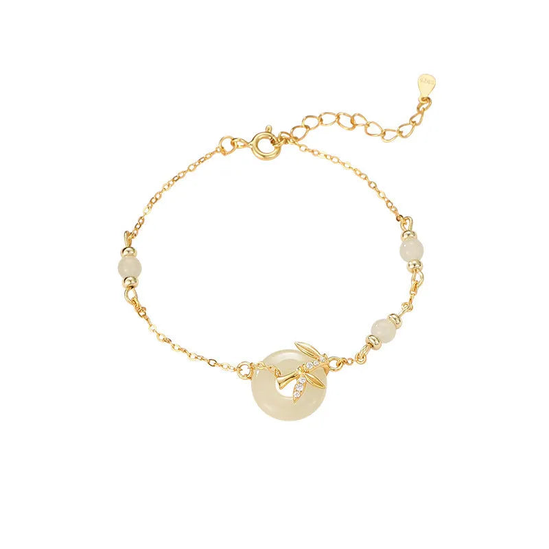 Women's antique style Hetian jade bracelet with a silver peace buckle clasp on a wrist.