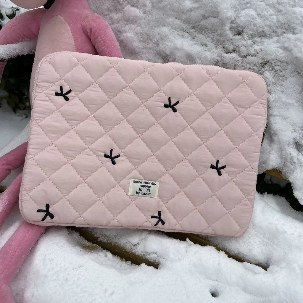 Nylon laptop storage bag with an embroidered rhombus bow in light pink colour.