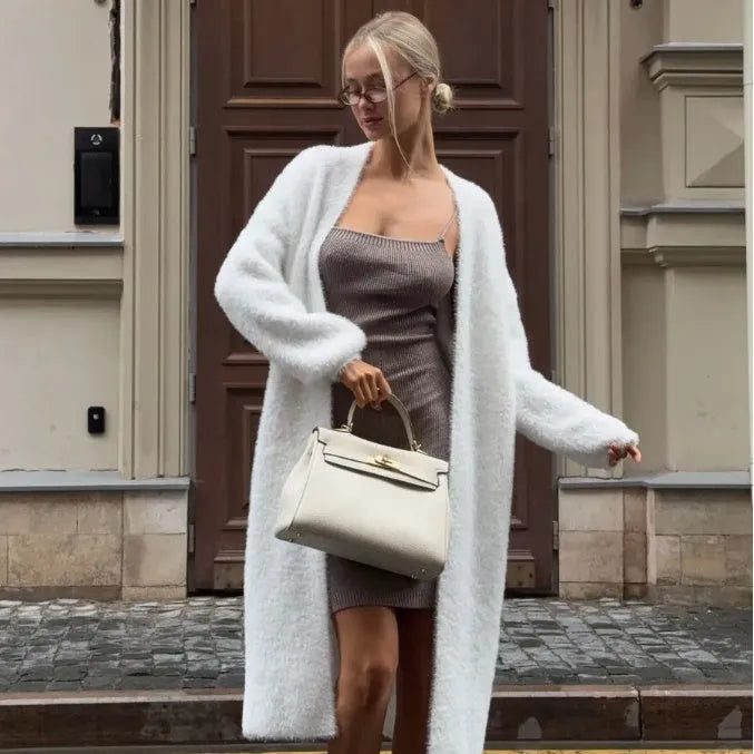 Long white women's cardigan jacket with loose fit and long sleeves.
