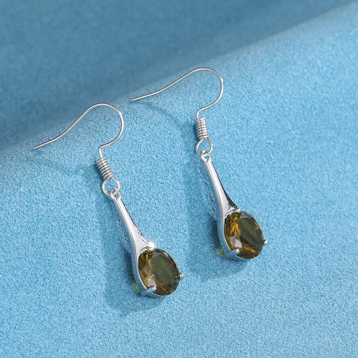 Olive green topaz drop earrings with water drop shape and retro styling