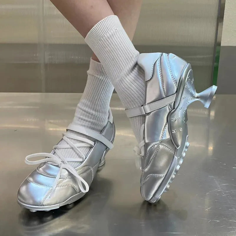Women's silver lace-up sports shoes with a decorative bow on the front.