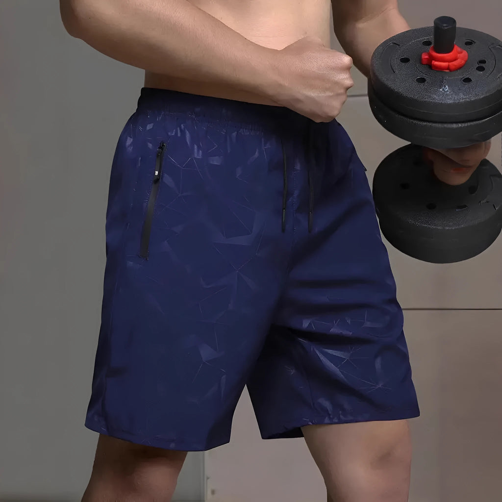 Man wearing loose-fit black printed polyester sports shorts for casual athletic wear.