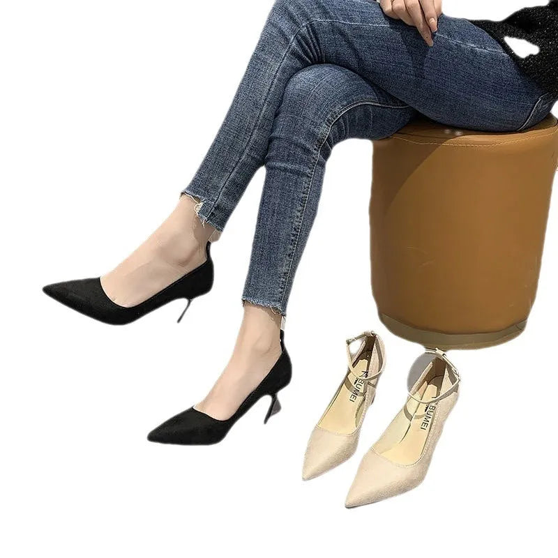Women's black stiletto heel pumps with skull pattern and buckle closure