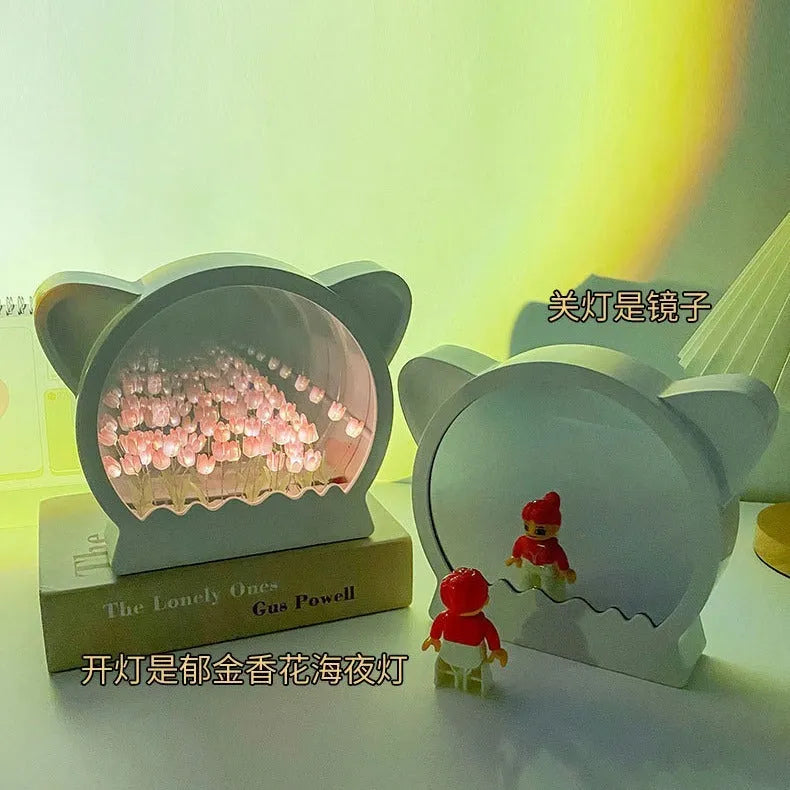 Assembled DIY cat head-shaped night lamp with pink artificial tulips on a white background.